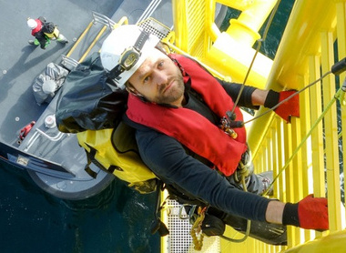 worker-offshore-climbing-down-from-wind-turbine-on-ladder-and-transfer-vessel.jpg